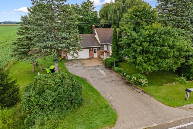 view of front of home with a front yard and a garage