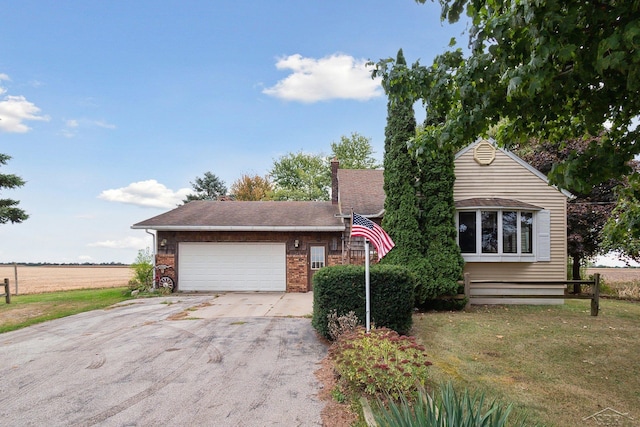 view of front of property featuring a rural view and a garage