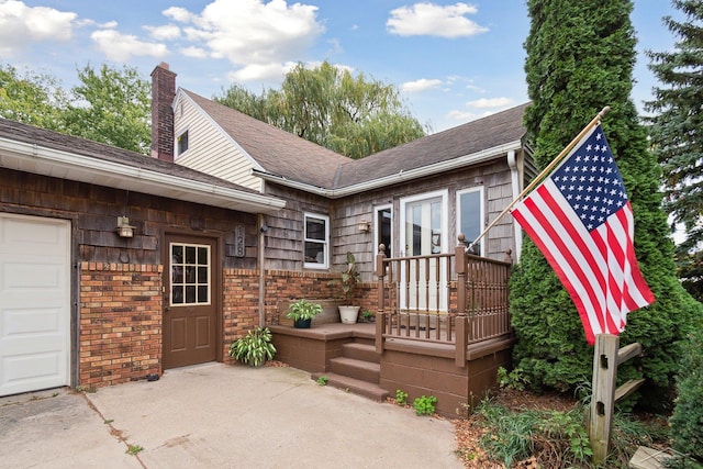 back of property featuring a garage