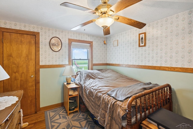 bedroom with hardwood / wood-style flooring and ceiling fan