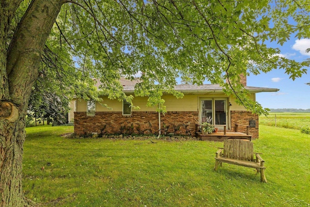 rear view of house featuring a lawn