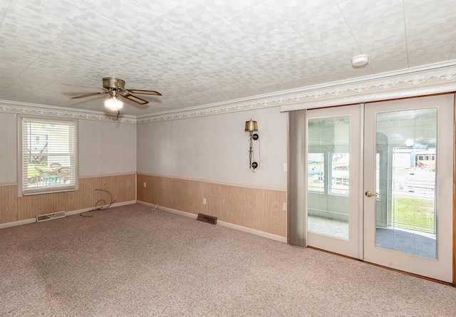 482 Swan Ln, Coldwater, MI 49036 - carpeted spare room featuring ceiling fan, a healthy amount of sunlight, wooden walls, and french doors