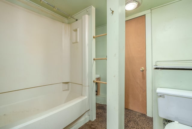 bathroom featuring shower / bath combination and toilet