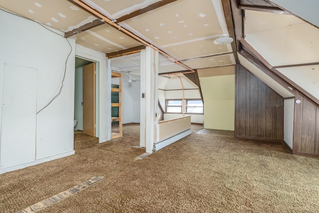 additional living space featuring carpet flooring and a baseboard heating unit