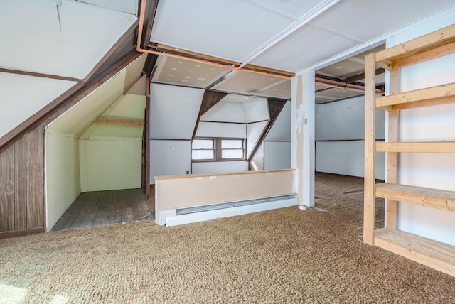 additional living space with dark carpet and vaulted ceiling