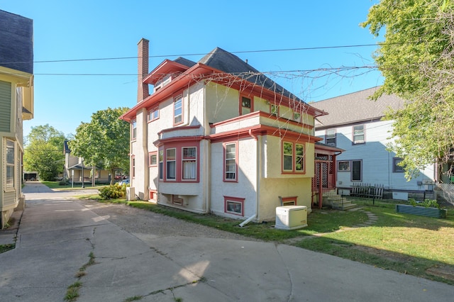 view of property exterior with a yard