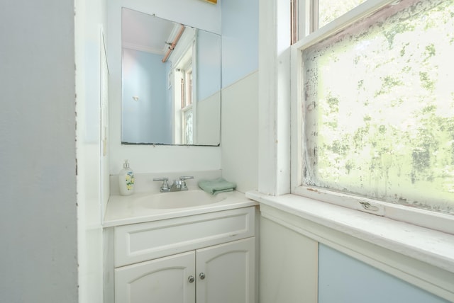 bathroom with crown molding and vanity