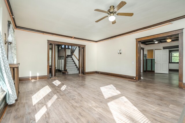 spare room with ceiling fan, crown molding, and wood-type flooring