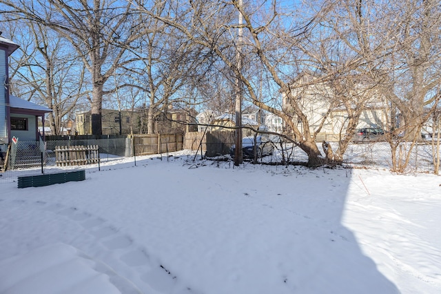 yard layered in snow featuring a trampoline