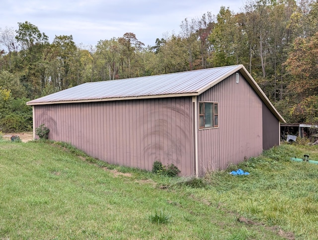 view of outbuilding featuring a yard