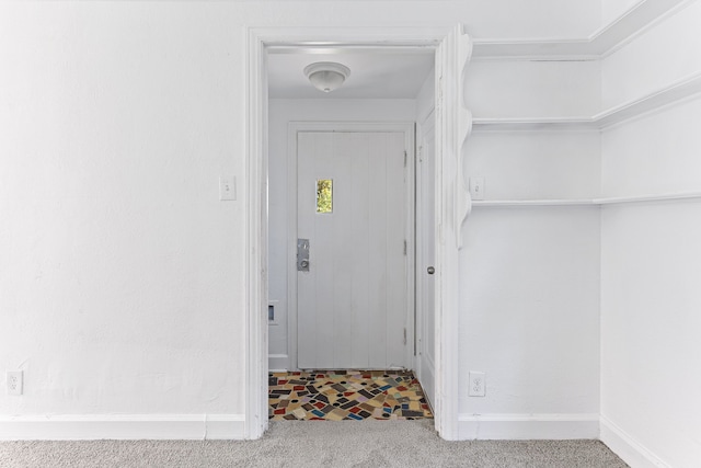 entrance foyer with carpet flooring