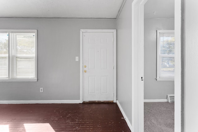 entrance foyer featuring dark hardwood / wood-style floors and crown molding