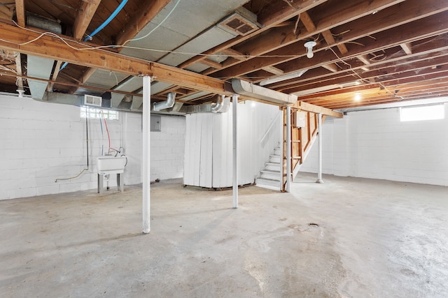 basement featuring a wealth of natural light and sink