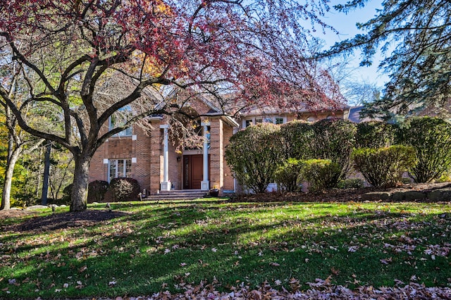 view of property hidden behind natural elements with a front lawn