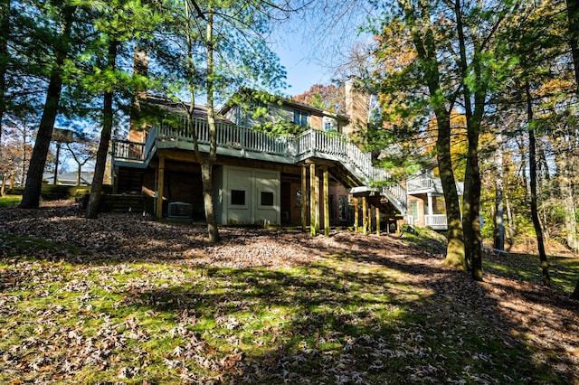 back of house featuring a wooden deck