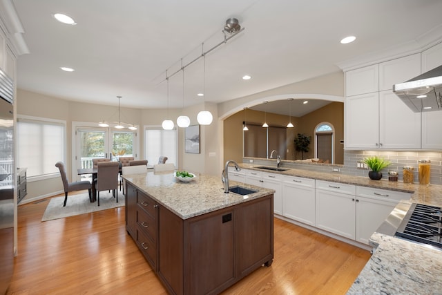 kitchen featuring white cabinetry, sink, pendant lighting, and track lighting