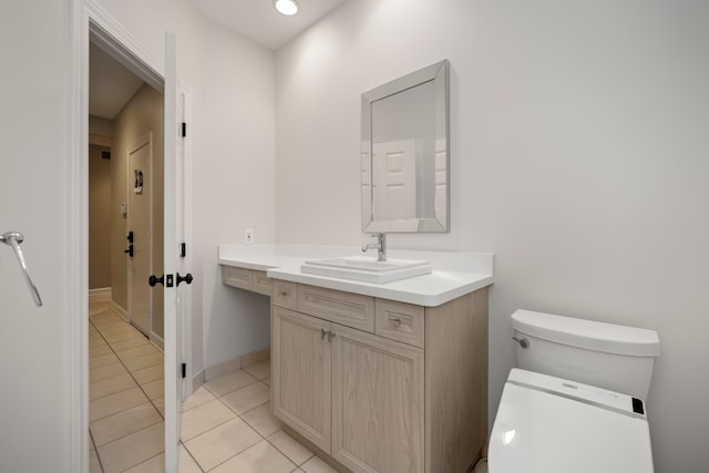 bathroom with tile patterned floors, vanity, and toilet