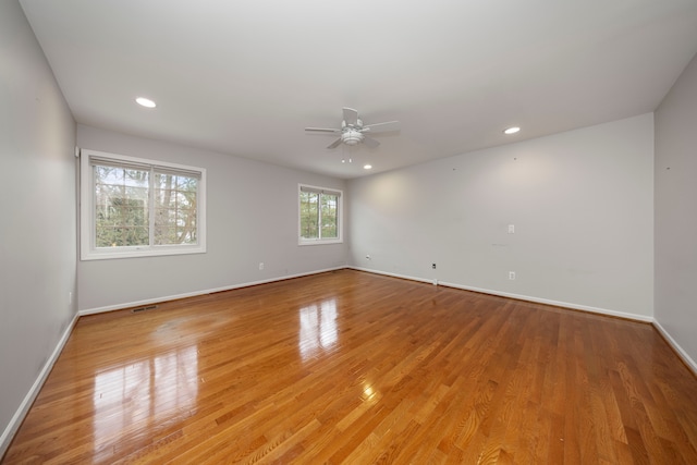 spare room featuring light hardwood / wood-style floors and ceiling fan