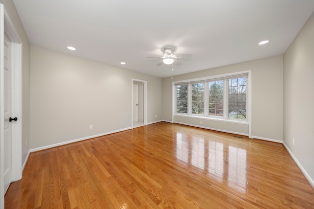 empty room featuring ceiling fan and light hardwood / wood-style floors