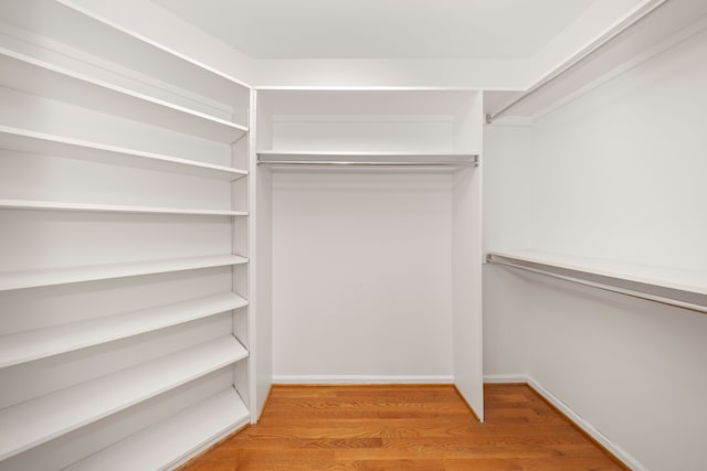 spacious closet with light hardwood / wood-style floors