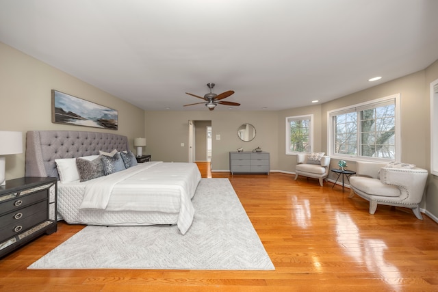 bedroom with ceiling fan and light hardwood / wood-style flooring