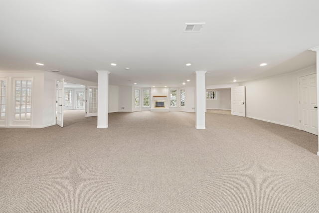 basement featuring light colored carpet and crown molding