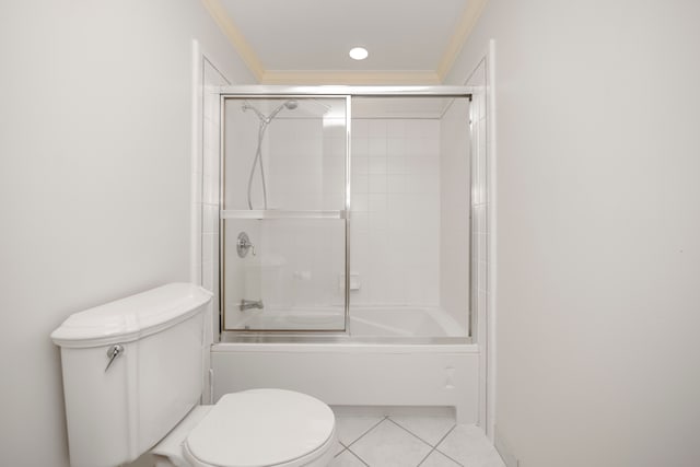 bathroom featuring tile patterned floors, shower / bath combination with glass door, ornamental molding, and toilet