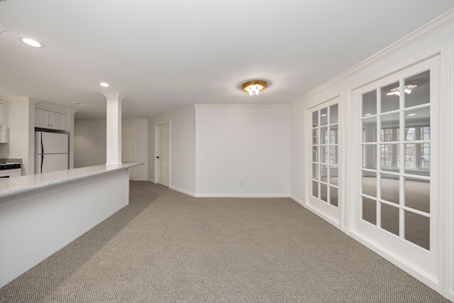 carpeted spare room featuring crown molding