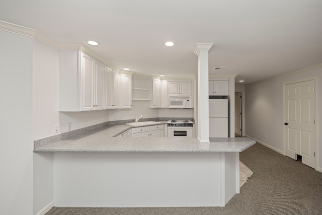 kitchen with kitchen peninsula, white appliances, white cabinetry, and sink