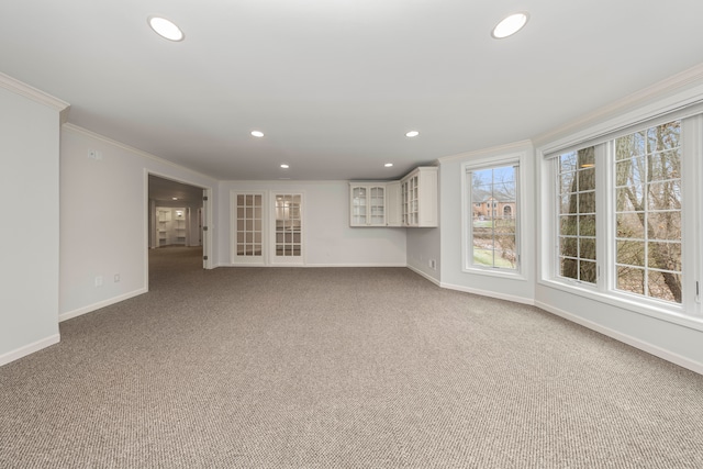 unfurnished living room featuring light colored carpet and crown molding