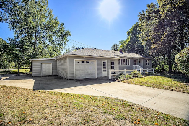 single story home with a front yard and a garage