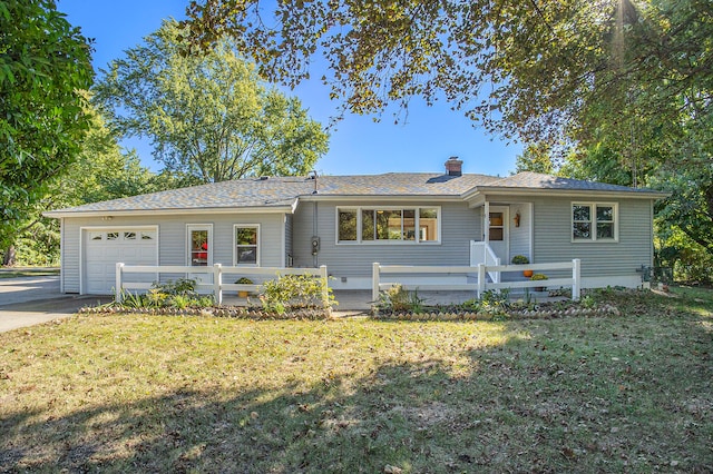 ranch-style house featuring a front lawn and a garage