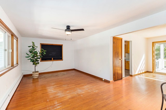 unfurnished room with ceiling fan, light hardwood / wood-style floors, and a baseboard radiator