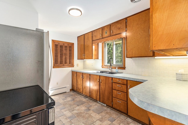 kitchen with a baseboard heating unit, tasteful backsplash, sink, and stainless steel appliances