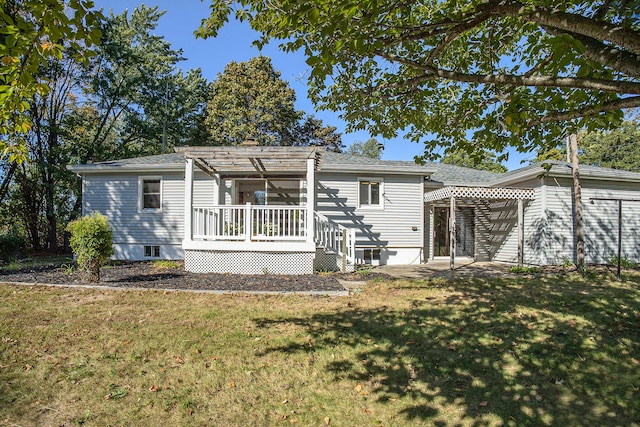 back of property featuring a pergola and a lawn