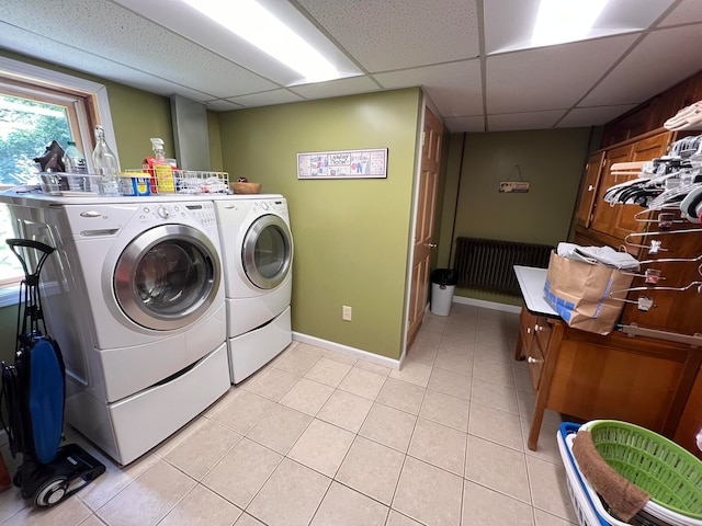 laundry area featuring light tile patterned flooring and washing machine and clothes dryer