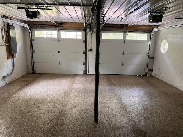 garage featuring electric panel and a garage door opener