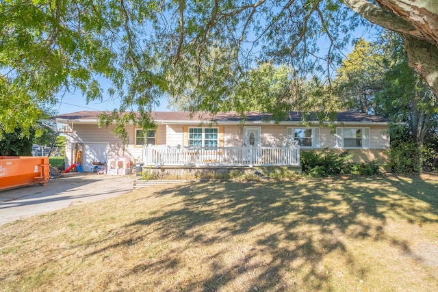 ranch-style house featuring a garage and a front lawn