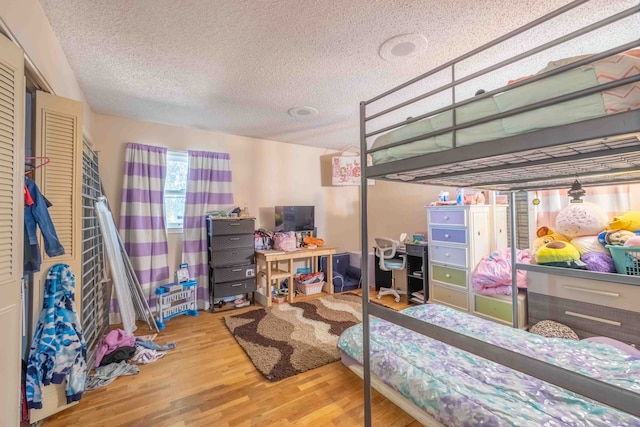 bedroom featuring a textured ceiling and hardwood / wood-style flooring