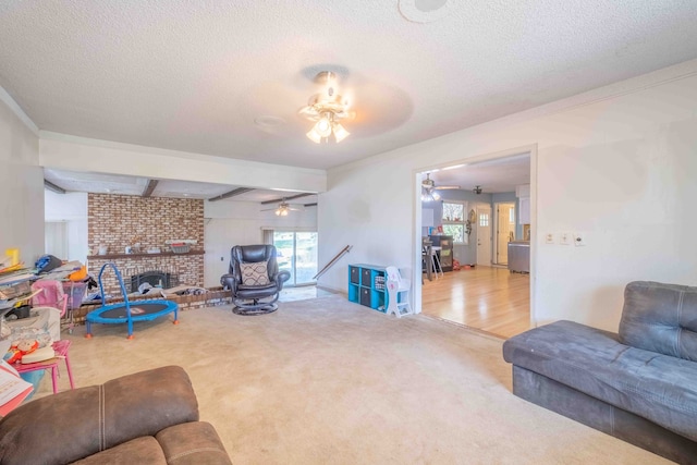 living room with carpet flooring, a fireplace, beam ceiling, and a textured ceiling