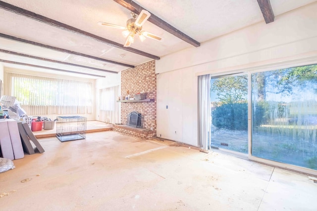 unfurnished living room featuring beam ceiling, a brick fireplace, and ceiling fan