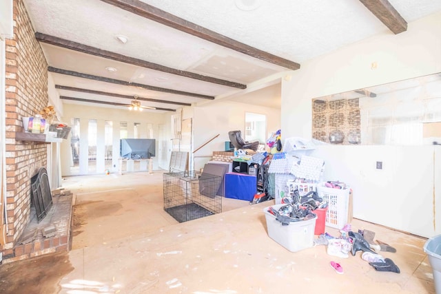 living room featuring beamed ceiling, ceiling fan, a textured ceiling, and heating unit