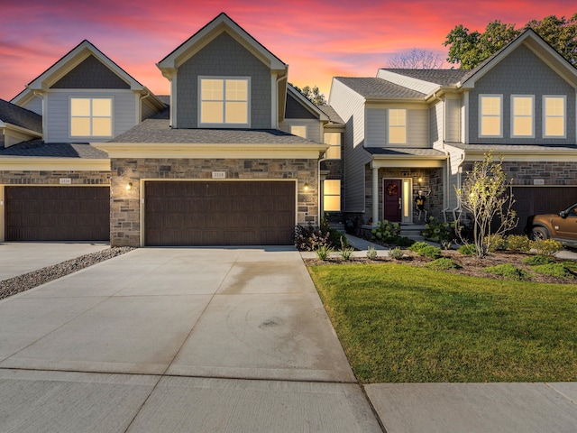 craftsman-style house with a yard and a garage