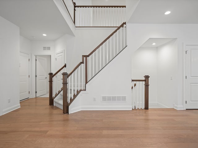 stairs with hardwood / wood-style flooring