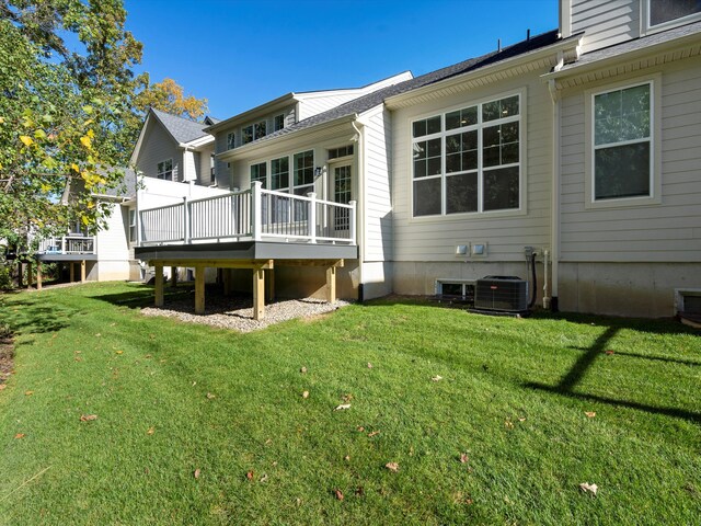 back of house with a yard, central AC unit, and a deck