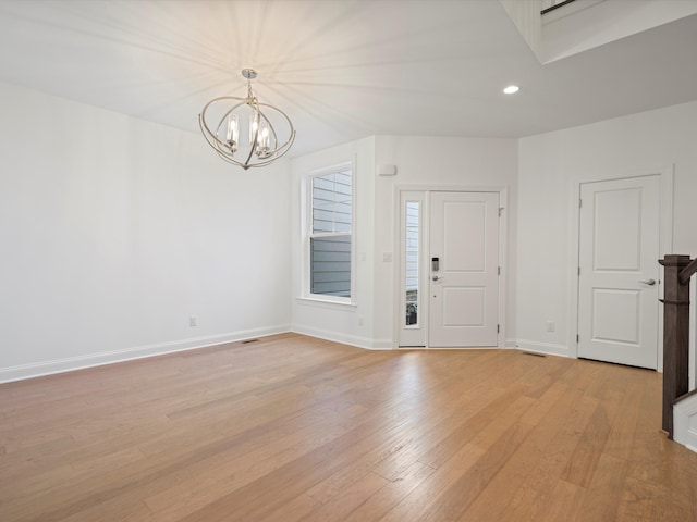 foyer with a notable chandelier and light hardwood / wood-style flooring