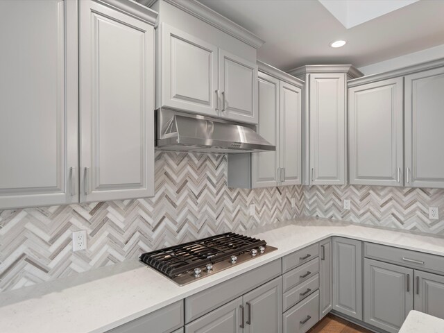 3318 Roseford Blvd, Ann Arbor, MI 48105 - kitchen featuring under cabinet range hood, gray cabinets, stainless steel gas cooktop, tasteful backsplash, and recessed lighting