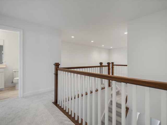 staircase featuring carpet