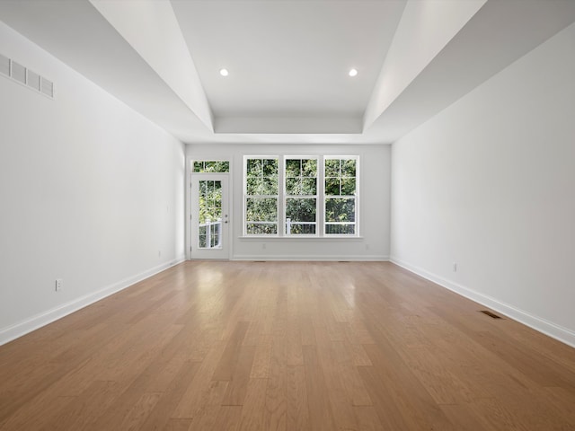 unfurnished living room featuring light wood-type flooring and vaulted ceiling