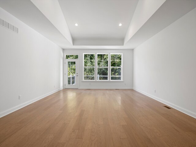 3318 Roseford Blvd, Ann Arbor, MI 48105 - empty room with baseboards, light wood-style flooring, a tray ceiling, and recessed lighting
